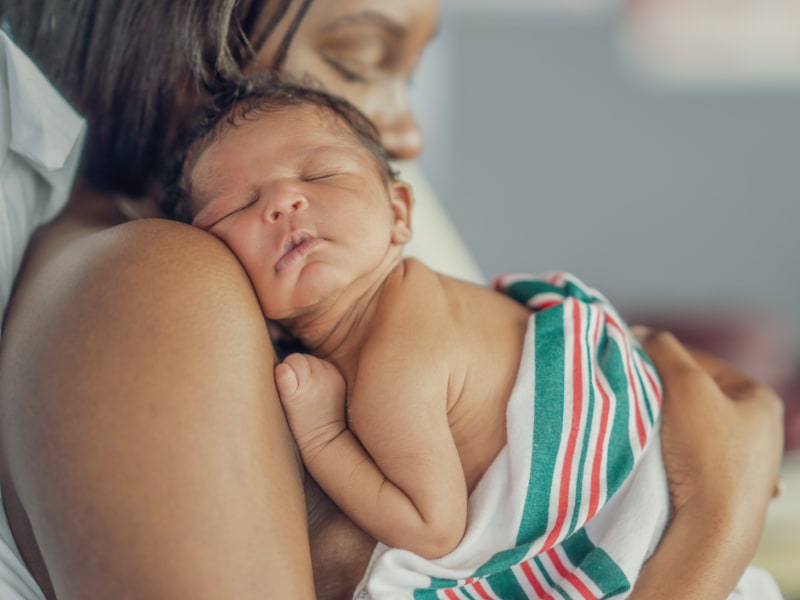 Mother holds her newborn child