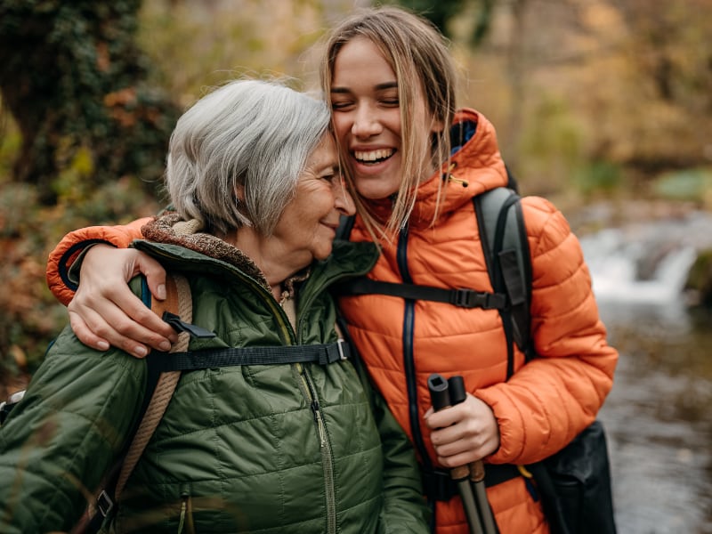 Woman hiking with her elderly mother