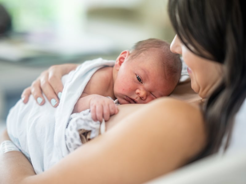 Mother holds her newborn child