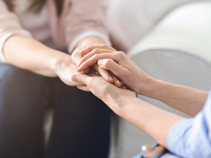 Doctor comforts a female patient